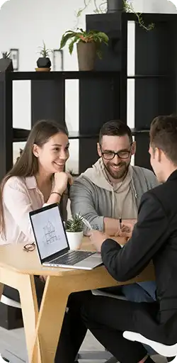 Couple sitting at desk with Loan Officer