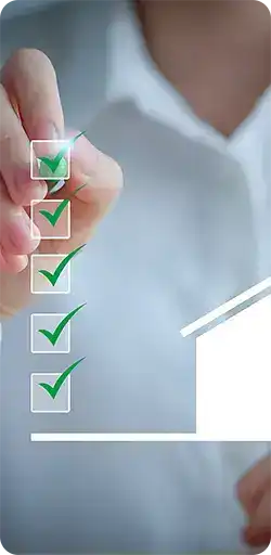 Person holding pencil marking check marks in boxes